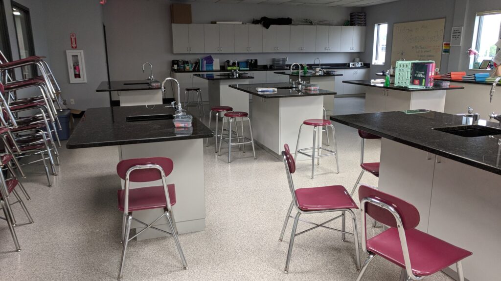 view of a science lab with work stations and chairs set up around the room