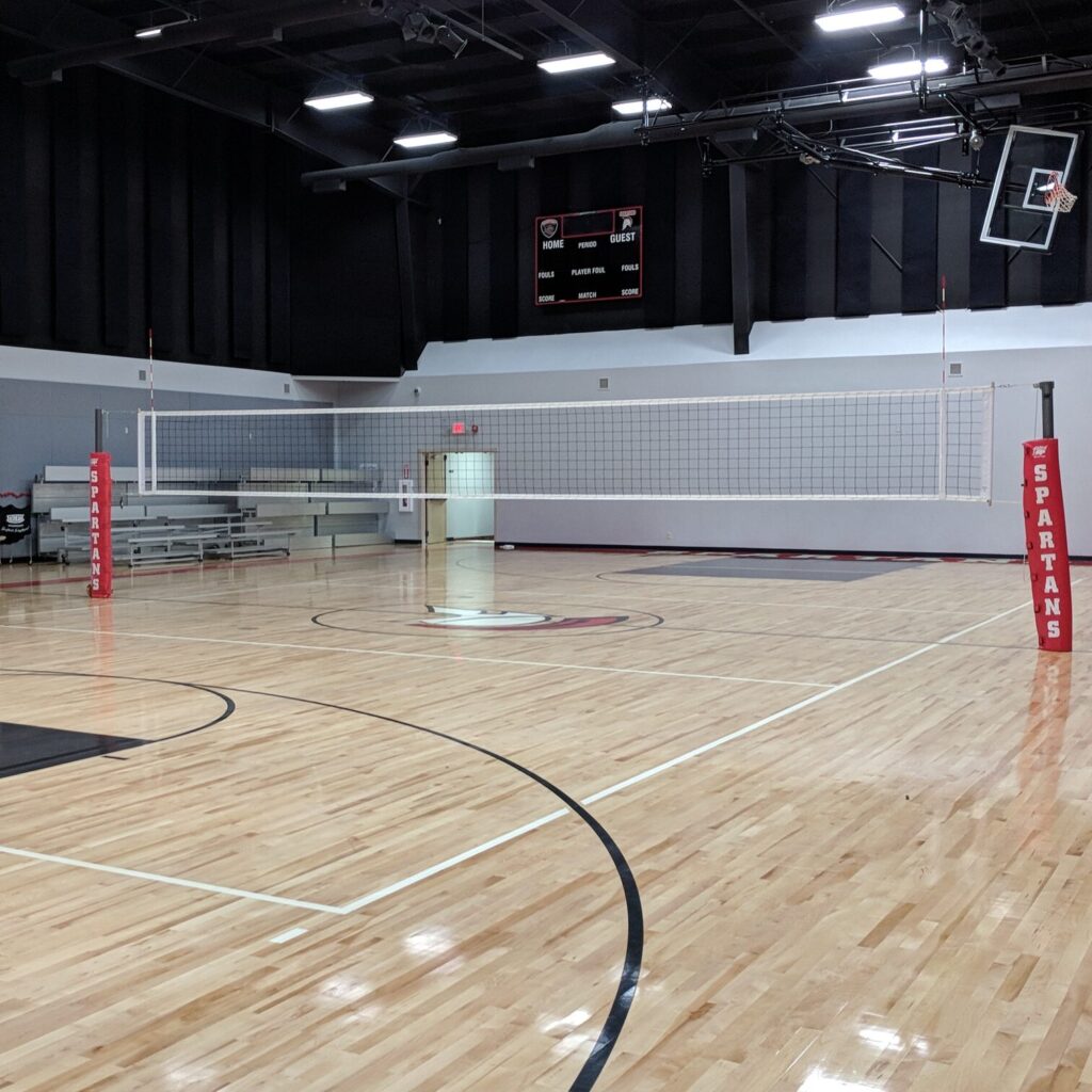empty gymnasium set up with the volleyball net