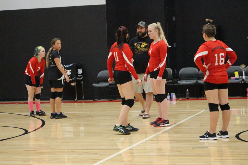 volleyball team on the court in the middle of a game