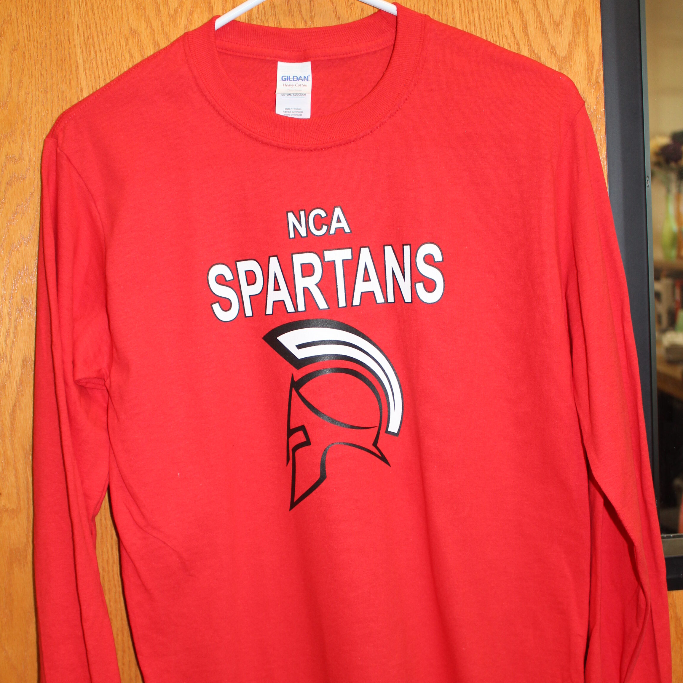 Red long sleeve t-shirt with the New Century Academy logo on it
