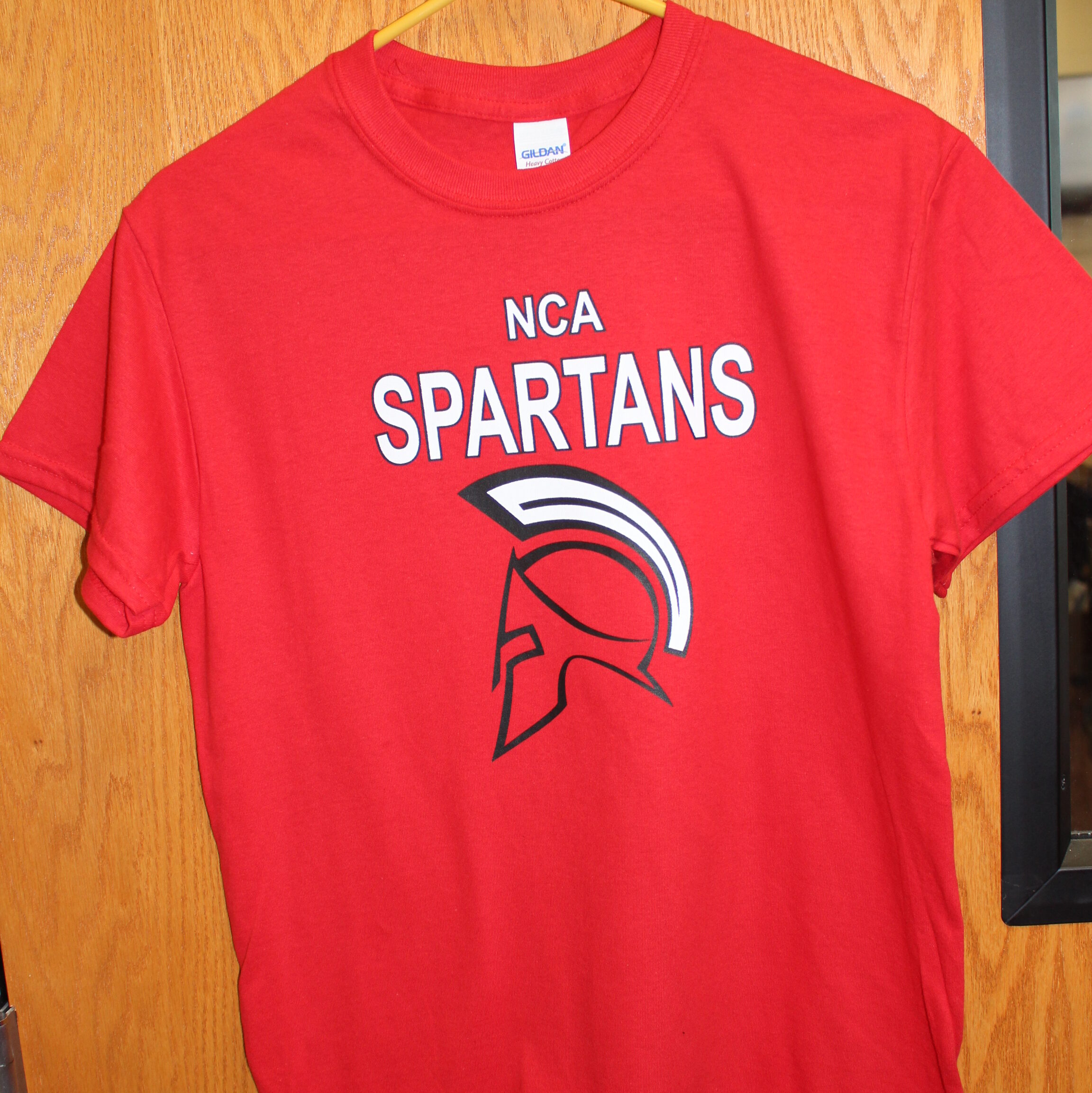 Red short sleeve t-shirt with the New Century Academy mascot on it