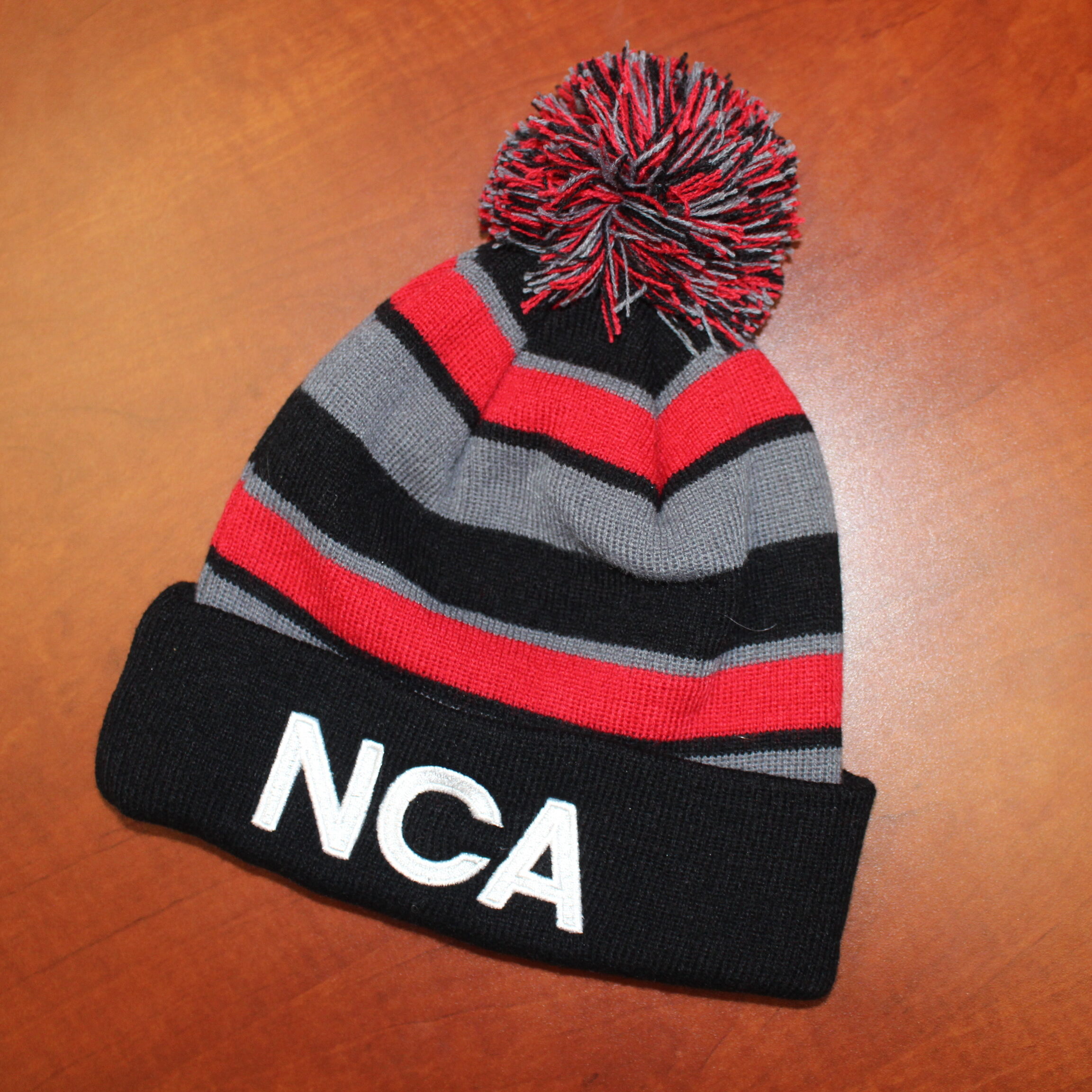 Stocking cap with school colors and the letters, "NCA" on it